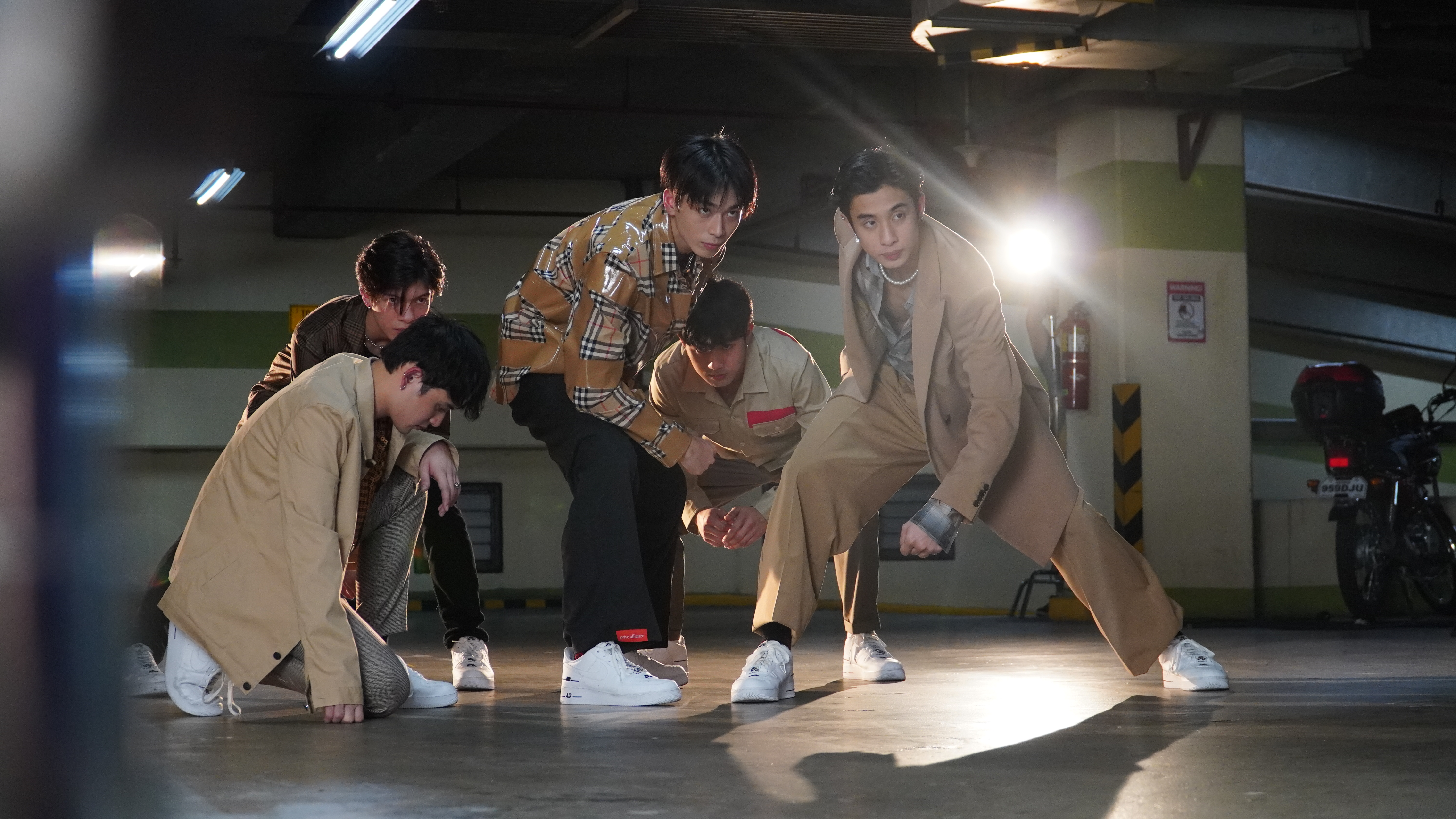 K-Pop group BGYO preforming in a parking garage.